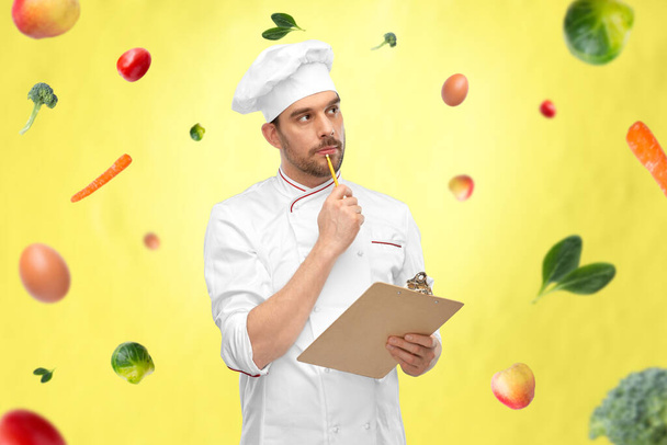 thinking male chef with clipboard - Zdjęcie, obraz