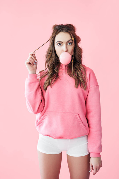 Young suprised woman blowing bubble from chewing gum - Photo, Image