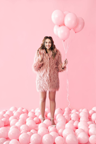 Full length portrait of happy glamour woman with pink balloons on pink pastel background - Fotó, kép
