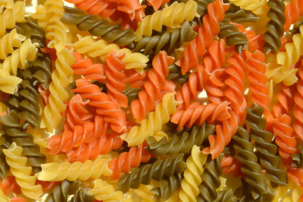 Close up of dry uncooked fusilli tricolore - Foto, Bild