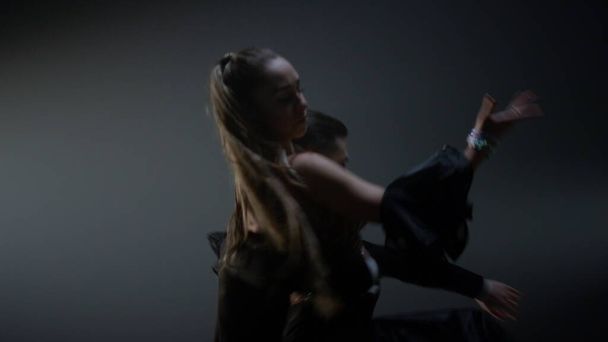 舞台上で女性を抱えている若い男。室内で回転する舞踏家 - 写真・画像