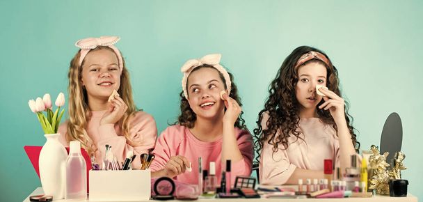 Sisterhood happiness. Happy womens day. Cosmetics shop. Girls only. Childhood happiness. Kids makeup. Skin care concept. Cosmetics for children. Beauty and fashion. Happy girls doing makeup together - Foto, afbeelding