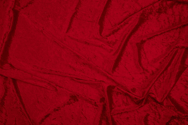 Βελούδα υφασμάτινο μονόχρωμο φόντο αφηρημένο κόκκινο φόντο. Χωρίς σχήμα άδεια επιφάνεια κατάλληλη για τη δημιουργία ενός άνετου, ευχάριστου, μαλακού, ζεστού, χειμώνα, φθινόπωρο, εορταστικού, ακριβού σχεδιασμού. αντίγραφο χώρου - Φωτογραφία, εικόνα