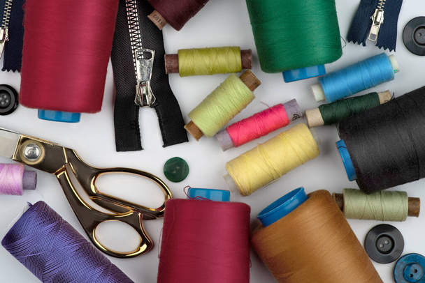 Bobbins, multi-colored spools of thread, sewing accessories on a white background. - Fotó, kép