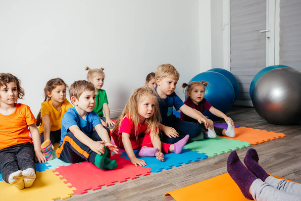 Children exercising while physical education lesson at preschool - Photo, Image