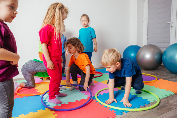 Sport activities with hula hoops at kindergarten - Φωτογραφία, εικόνα