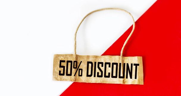 Label with a 50 percent discount sign on a white and red background. - Fotografie, Obrázek