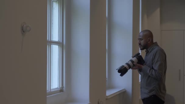 Felnőtt UK ázsiai kopasz férfi vesz megfigyelési fotók irodai ablakból. Lezárva - Felvétel, videó