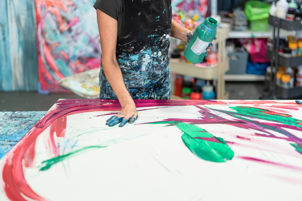 Γυναίκα καλλιτέχνης ζωγραφική με τα χέρια σε καμβά στο εργαστήριο στούντιο - Ζωγράφος έργο και δημιουργική τέχνη έννοια - Φωτογραφία, εικόνα