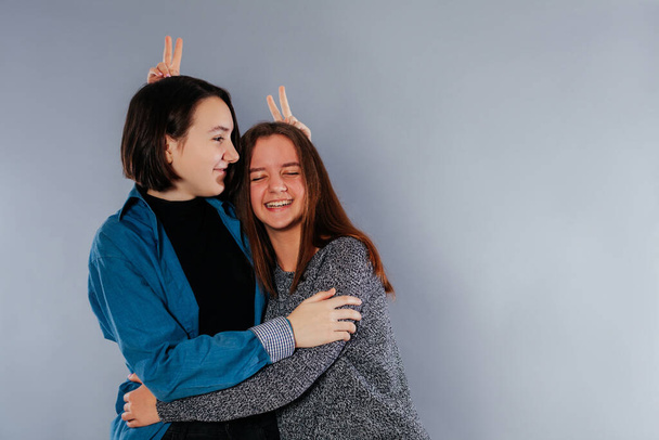 Two teenage sisters are hugging each other - Photo, image