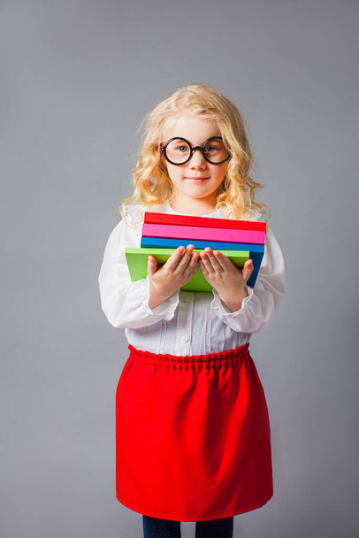 The pretty little girl with glasses dressed in teacher uniform - Foto, afbeelding