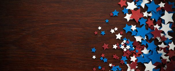 4th of July American Independence Day stars decorations on wooden background. Flat lay, top view. - 写真・画像