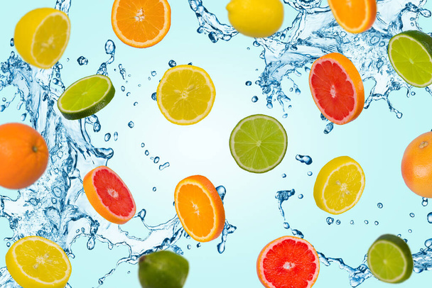 Minimal idea with sliced orange, lemon, lime and grapefruitwith water splash on a blue background. Minimal concept with several different types of citrus fruit. Vitamins, healthy diet concept. Sliced and whole citrus fruits floating in the air. Creat - Photo, Image