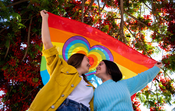 lesbian girls vindicating the lgtb movement with an lgtb flag - Foto, immagini