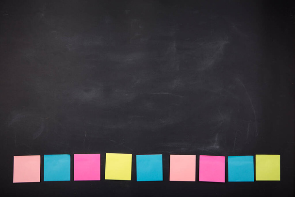 Colorful sticky notes on the blank blackboard - Foto, Imagen