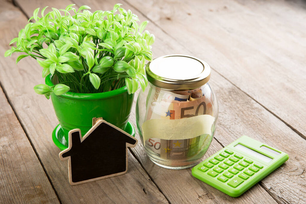 Real estate finance concept - money glass with Rent word and vintage key - 写真・画像