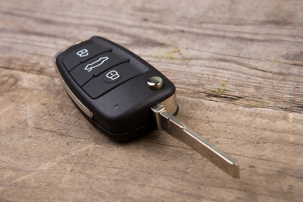 Car key with remote alarm control on the wooden desk - Photo, Image