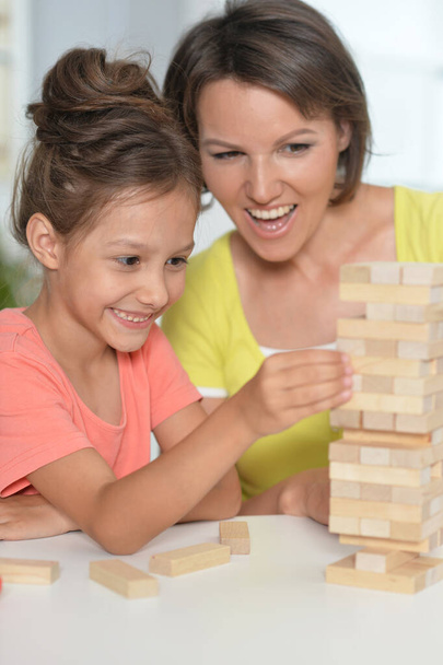 mother and daughter playing with wooden blocks  - 写真・画像