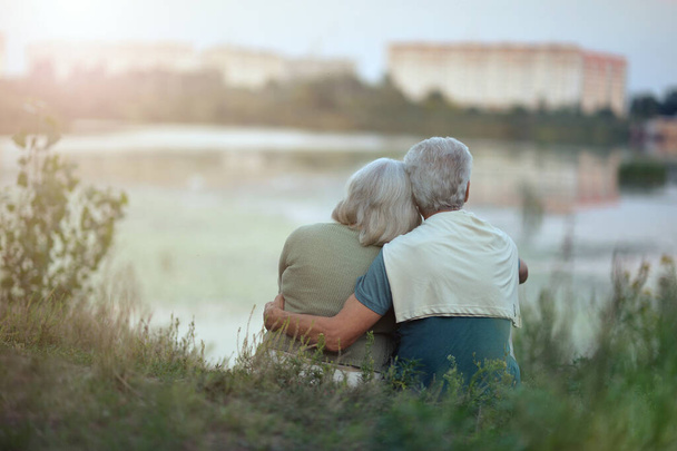  senior couple posing in the park by lake  - Foto, immagini