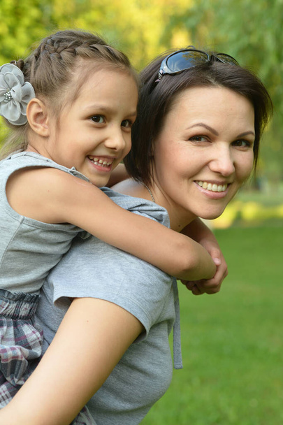 Portrait of  happy mother and daughter smiling  outdoors - Foto, Bild