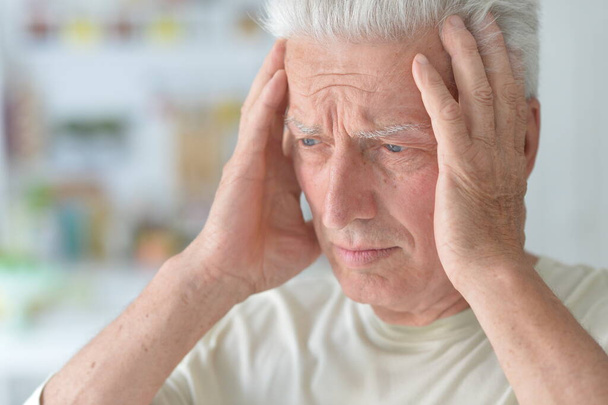 Portrait of sad sick senior man with headache  - Фото, изображение
