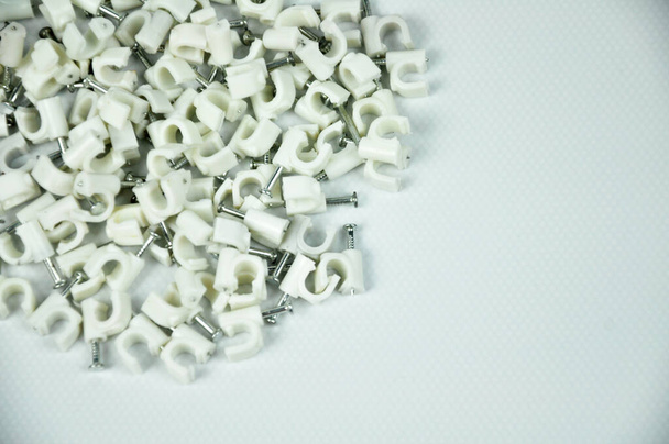 Pinzas de cable de plástico con clavos de hormigón aislados sobre fondo blanco - Foto, Imagen