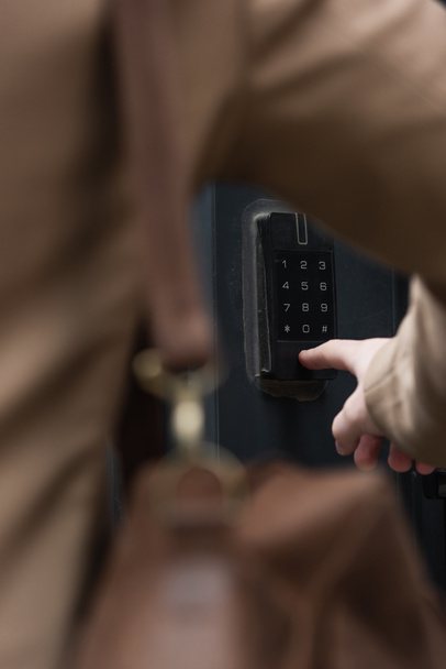 partial view of blurred man pressing button on intercom keypad  - Photo, Image