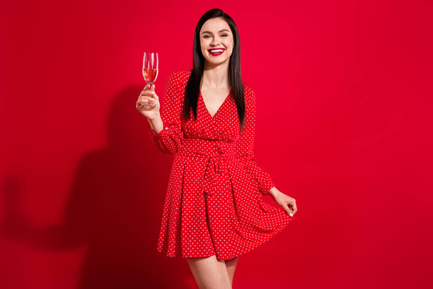 Photo of classy brunette lady hold glass drink beverage wear red dress isolated on vivid color background - Foto, Bild