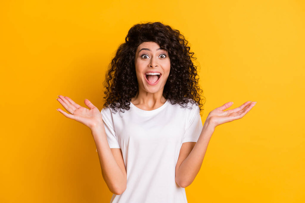 Photo portrait of amazed surprised girl happy cheerful gesturing hands isolated on vibrant yellow color background - Foto, Imagem