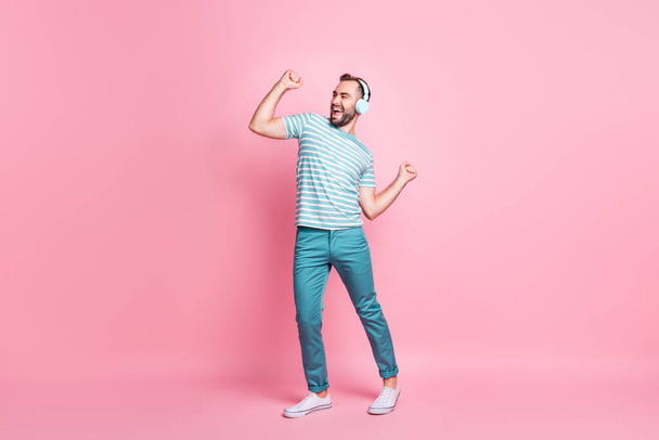 Full length body size view of nice cheerful guy listening melody rock bass having fun dancing isolated over pink color background - Фото, изображение