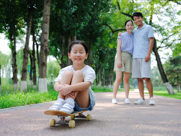 A Happy family of three skateboarding - Fotó, kép