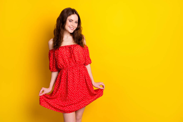 Photo portrait of curly girl smiling in red fancy printed dress isolated bright yellow color background blank space - Foto, imagen