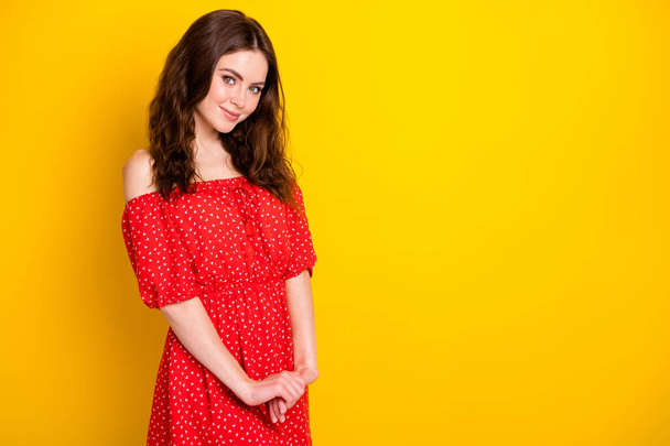 Photo portrait of happy girl with wavy hair in red dress smiling in summer isolated vibrant yellow color background - Foto, Imagem