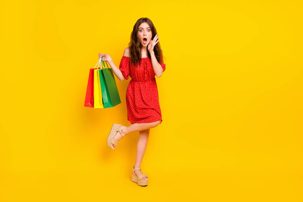 Full length photo of impressed girl arm on cheek open mouth cant believe isolated on yellow color background - Фото, изображение