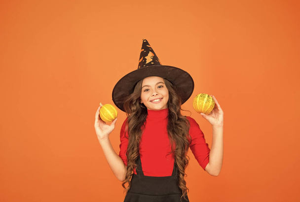 Happy to be around. childhood leisure. jack o lantern. happy halloween. kid wear witch hat. child with small pumpkin. teen girl has long hair wear dress for party celebration. autumn season holiday - Photo, image