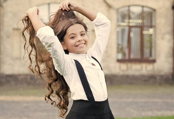 beautiful student teen girl has long hair. cute smiling confident schoolgirl jumping. sense of freedom. back to school. Small girl wear school uniform. beauty and fashion - Photo, Image