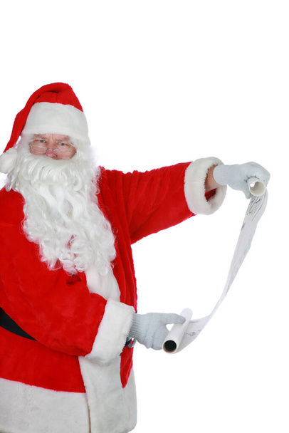 Santa Claus.  Santa Claus Isolated on white. Room for text. Santa Claus poses for his Christmas Portrait against a white wall. Clipping path. Santa says HO HO HO. Merry Christmas. Happy New Year to all. Santa reads from his list. - Photo, image
