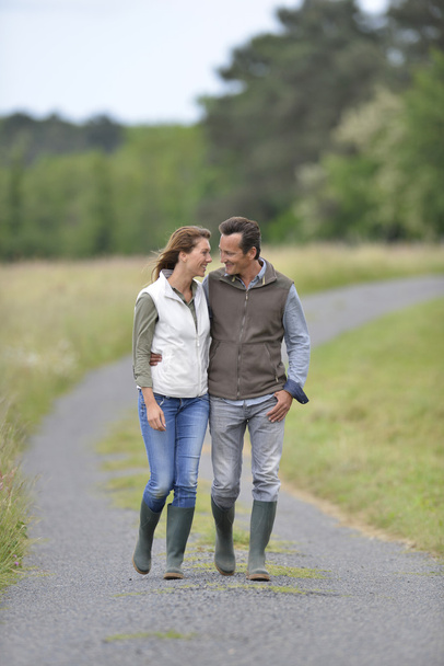 Couple walking in countryside - Фото, изображение