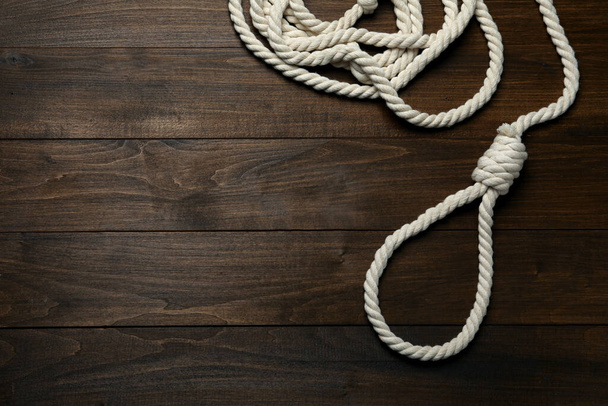 Rope noose on wooden table, top view. Space for text - Photo, Image