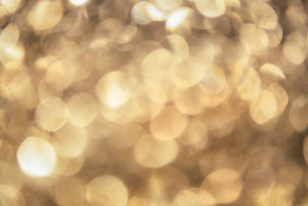 A closeup shot of golden bokeh light effects - perfect for background - 写真・画像