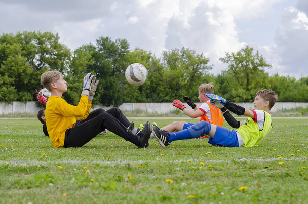 STERLITAMAK, RUSSIA - Jul 21, 2019: Young soccer goalkeepers train on a green lawn. Preparing athletes for future victories on the football field. - Photo, image