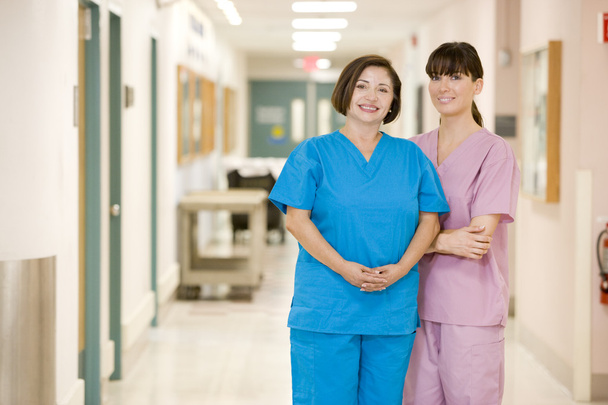 Two Female Nurses Standing In A Hospital Corridor - Foto, imagen