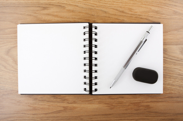 Open empty notebook with pen and eraser - Foto, Bild