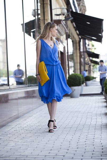 Young beautiful woman in a blue dress  - 写真・画像