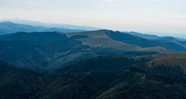 Beautiful Carpathian mountains in Romania - Muntii Valcan mountains from Cadea Oslei hill with hills covered by mountain meadows and deep forest - Φωτογραφία, εικόνα