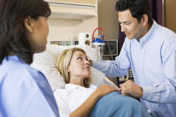 Doctor Talking To Pregnant Woman And Her Husband - Photo, Image