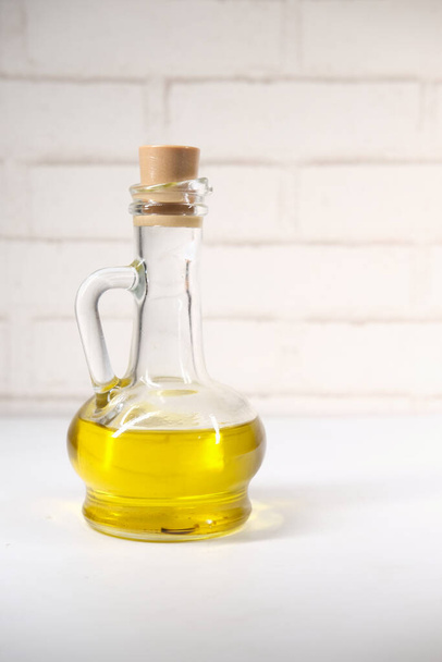 bottle of olive oil on table  - 写真・画像