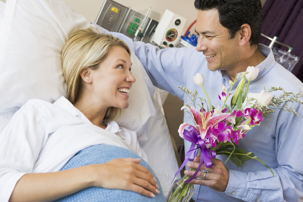 Mann schenkt seiner schwangeren Frau Blumen - Foto, Bild
