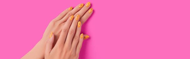 Manicured womans hands with trendy nail design on pink background - Photo, Image