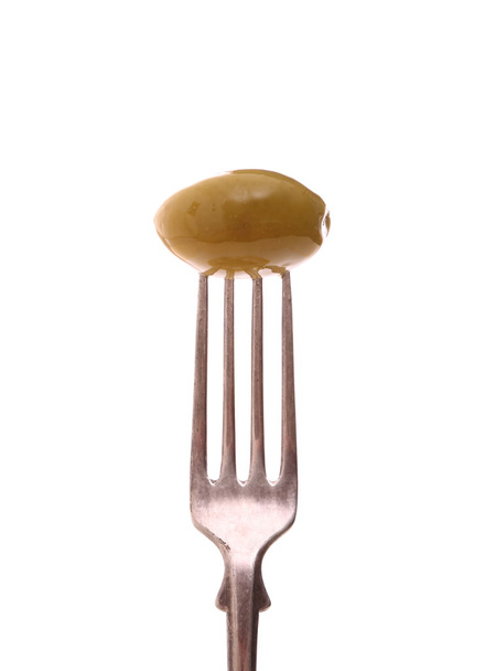 Big green olive on fork, isolated - Photo, Image